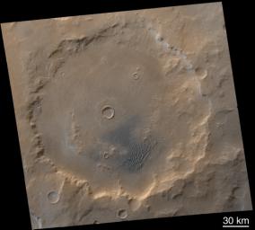 NASA's Mars Global Surveyor shows dark-gray or blue-black sand shaded with light-toned frosted dunes in Kaiser Crater on Mars.