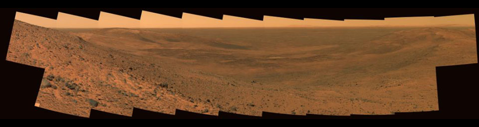This image from NASA's Mars Exploration Rover Spirit taken on Nov 2, 2005 shows an impact feature called 'East Basin.' Dark features on the far side of the basin are basaltic sand deposits emplaced on the lee sides of hills by northwesterly winds.