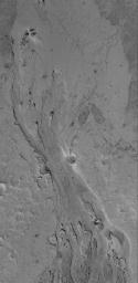 NASA's Mars Global Surveyor shows a portion of a shallow channel carved in the plains of the Zephyria region of Mars. This feature might be the result of the passing of either extremely fluid lava or, perhaps, mud.