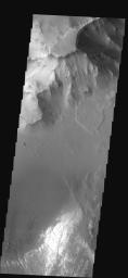 This image shows part of Ganges Chasma on Mars. Several landslides occur at the top of the image, while dunes and canyon floor deposits are visible at the bottom of the image as seen by NASA's 2001 Mars Odyssey spacecraft.