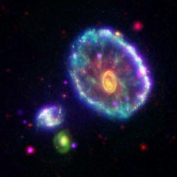 This false-color composite image shows the Cartwheel galaxy as seen by NASA's Galaxy Evolution Explorer, where the first ripple appears as an ultraviolet-bright blue outer ring.