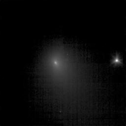 This image of comet Tempel 1 is a compilation of nine images that were taken on June 19, 2005 by NASA's Deep Impact spacecraft. A star to the right is six times brighter than the brightest pixel of the comet.