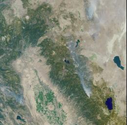 These images from NASA's Terra satellite are of the Central Valley and the Sierra Nevada Mountains showing several smoke plumes from wildfires burning throughout Northern California on August 13, 2001.