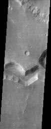 This image from NASA's Mars Odyssey spacecraft shows a sinuous valley network channel with sharp bends cutting across the cratered highlands of the southern hemisphere of Mars.