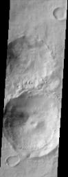 This scene shows gullies superposed on the inner walls of four large craters. Most of these gullies, imaged by NASA's Mars Odyssey spacecraft, appear to emanate from one or two specific layers along the inner crater's entire circumference.