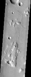 This lunar-like scene, imaged by NASA's Mars Odyssey spacecraft, occurs along the southeastern rim of the Isidis Planitia basin, an ancient impact crater some 1200 km across.