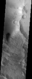 This scene from NASA's Mars Odyssey shows the contrasting morphologies of the relatively rough highland terrain (in the lower portion of the image) and the relatively smooth materials (at top) of the southern rim of the Isidis Planitia basin.