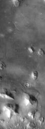The so-called 'Face on Mars' can be seen slightly above center and to the right in this NASA Mars Odyssey image. This 3-km long knob was first imaged by NASA's Viking spacecraft in the 1970's and to some resembled a face carved into the rocks of Mars.