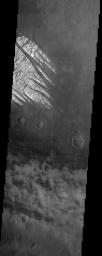 White Rock' is the unofficial name for this unusual landform which was first observed during NASA's Mariner 9 mission in the early 1970's and is now shown here in an image from NASA's Mars Odyssey spacecraft.