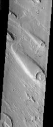 Streamlined islands, like the one shown in this NASA Mars Odyssey image, are one piece of geologic evidence that large quantities of water once flowed across the surface of Mars in the distant past.