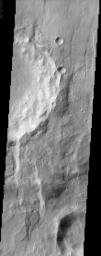 The eastern rim of this unnamed crater in Claritas Fossae is very degraded, as seen in this image from NASA's Mars Odyssey, indicating that it's very ancient and has been subjected to erosion and bombardment from impactors such as asteroids and comets.