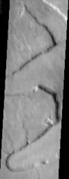 This NASA Mars Odyssey image shows several 'fretted' channels within Deuteronilus Mensae in the northern plains of Mars. These linear troughs appear to have been extensively modified by surficial processes.