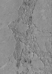 NASA's Mars Global Surveyor shows some of the platy flow material in the Zephyria region of Mars. The materials have impact craters in them, suggesting that they are composed of solid rock rather than ice.