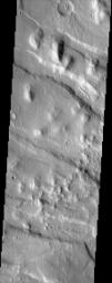 Located north of Olympus Mons and west of Alba Patera, Acheron Fossae, seen in this NASA Mars Odyssey image, provides a record of early tectonic activity in the Tharsis region.