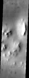 The muted terrain of northern Acidalia Planitia, as seen in this image from NASA's Mars Odyssey spacecraft, testifies to the fact that the region is heavily mantled with dust.
