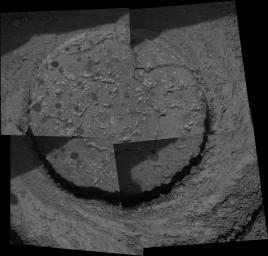 On Aug 6, 2005, NASA's Mars Exploration Rover Opportunity took this image showing rounded concretions dubbed 'blueberries.' A drill hole cut into a martian rock nicknamed 'Ice Cream' by the rover's rock abrasion tool is also shown.