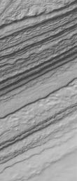 NASA's Mars Global Surveyor shows a frost-covered slope in the south polar region of Mars. The layered nature of the terrain in the south polar region is evident in a series of irregular, somewhat stair-stepped bands.