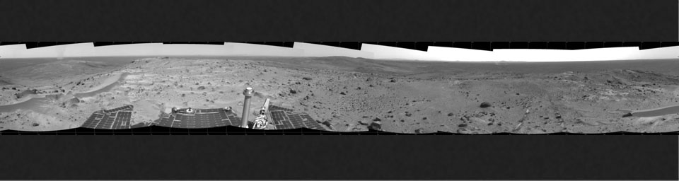 NASA's Spirit rover took this image from the summit of 'Husband Hill,' where three dust devils are clearly visible in the plains of Gusev Crater.