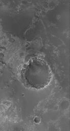 NASA's Mars Global Surveyor shows a crater formed in light-toned, layered, sedimentary rocks in Meridiani Planum on Mars. Erosion of sedimentary rock layers around the crater rim has caused an uneven retreat.