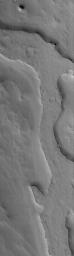 NASA's Mars Global Surveyor shows an inverted valley in eastern Arabia Terra on Mars. The relatively flat-topped ridge was once the floor, or a material covering the floor, of an ancient martian valley.
