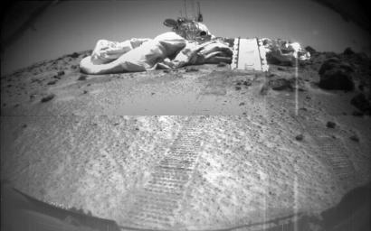This image of the Mars Pathfinder Lander on the surface of Mars was imaged by NASA's Sojourner as it looks back. Sojourners tracks are visible in the foreground. Sol 1 began on July 4, 1997.