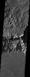 The impact crater observed in this NASA Mars Odyssey image taken in Terra Cimmeria suggests sediments have filled the crater due to the flat and smooth nature of the floor compared to rougher surfaces at higher elevations.