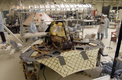 A 'Martian mechanic' checks beneath the completely deployed NASA's Rover 1 lander. Atop the lander is Rover 1 with its wheels and solar arrays in the stowed position.