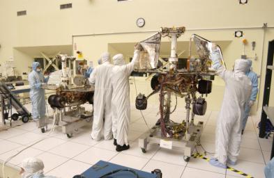 JPL engineers hand-deploying the solar arrays that provide the electrical power on NASA's Mars Exploration Rover 1.