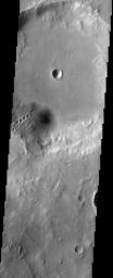 The large crater at the top of this image from NASA's Mars Odyssey spacecraft has several other craters inside of it. Most noticeable are the craters that form a 'chain' on the southern wall of the large crater.
