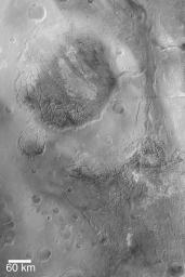 NASA's Mars Global Surveyor shows the large, circular feature Aram Chaos, an ancient impact crater on Mars filled with layered sedimentary rock that was later disrupted and eroded to form a blocky, 'chaotic' appearance.