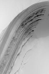 NASA's Mars Global Surveyor shows a springtime view of frost-covered layers revealed by an eroded scarp in the martian north polar cap. The layers are thought to consist of a mixture of dust, ice, and possibly sand.