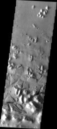 This image taken by NASA's 2001 Mars Odyssey showing large, tilted blocks of chaotic terrain in Masursky Crater on Mars. Chaotic terrain is thought to occur when subsurface water is suddenly released to the surface.