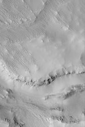NASA's Mars Global Surveyor shows small ridges known as yardangs located southwest of Olympus Mons near Gordii Dorsum on Mars.