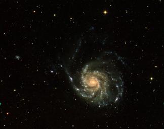 This three-color image of galaxy M101 was taken by NASA's Galaxy Evolution Explorer on June 20, 2003. The far ultraviolet emissions are shown in blue, the near ultraviolet emissions are green, and the red emissions, taken from NASA's Digital Sky Survey.