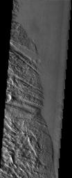 NASA's Mars Odyssey spacecraft captured this image in July 2003, roughly halfway between the great volcanoes of Olympus Mons and Pavonis Mons, the graben (troughs) of Ulysses Fossae intersect with the furrows of Gigas (gigantic) Sulci.