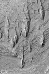 NASA's Mars Global Surveyor shows a mound of layered sedimentary rock that stands higher than the rim of Gale crater on Mars.