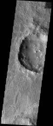 NASA's Mars Odyssey spacecraft captured this image in August 2003, showing Koga crater, named for a town in Tanzania. It is located in a region called Claritas Fossae on Mars. A mantle of fine material that is draped over much of the terrain.