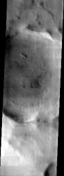 NASA's Mars Odyssey spacecraft captured this image in September 2003, showing a crater on Mars along the southeast rim of the Hellas Basin,hosting an eroded layered deposit like many of the neighboring craters.