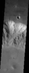 This image taken in October 2003 by NASA's Mars Odyssey spacecraft shows the northern rim of one of the Valles Marineris canyon; spurs and gullies in the canyon wall disappear some distance below the top of the canyon wall.