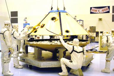 Technicians maneuver the aeroshell for Mars Exploration Rover 2 onto a workstand in the Payload Hazardous Servicing Facility.