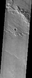 This image is located within a set of eroded layered rocks known as the Medusae Fossae Formation. This image was captured by NASA's Mars Odyssey spacecraft in November 2003.