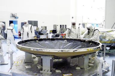 Workers in the Payload Hazardous Servicing Facility prepare the heat shield that will be attached to the backshell, surrounding Mars Exploration Rover 1 (MER-1).