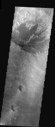 Less than 100 km from an outlier of the hematite deposit, a 30 km-diameter crater displays layers of eroding material, none of which contains hematite. This image was captured by NASA's Mars Odyssey spacecraft in November 2003.
