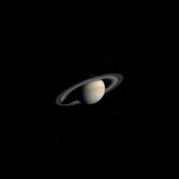 A cold, dusky Saturn looms in the distance in this striking, natural color view of the ringed planet and five of its icy satellites. This image was taken by NASA's Cassini's narrow angle camera on Nov. 9, 2003, from a distance of 111.4 million kilometers.