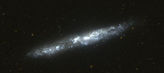This image of the nearby edge-on spiral galaxy NGC 55 was taken by NASA's Galaxy Evolution Explorer on September 14, 2003, during 2 orbits. This galaxy lies 5.4 million light years from our Milky Way galaxy.
