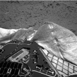 This image, taken by the navigation camera onboard NASA's Mars Exploration Rover Spirit, shows the airbags used to protect the rover during landing in 2004. One bright, dust-covered bag is slightly puffed up against the lander. 