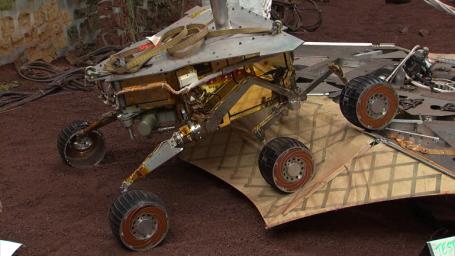 This still image illustrates what the Mars Exploration Rover Spirit will look like as it rolls off the northeastern side of the lander on Mars. The image was taken from footage of rover testing at JPL's In-Situ Instruments Laboratory, or 'Testbed.'