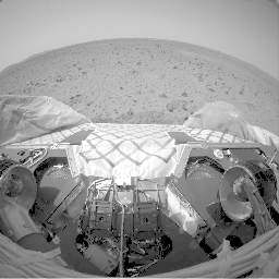 This image shows the view from the front hazard avoidance cameras onboard NASA's Mars Exploration Rover Spirit before the rover begins a crucial 3-point turn to face in a west direction and roll off the lander. 
