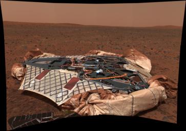 NASA's Mars Exploration Rover Spirit shows the rover's landing site, the Columbia Memorial Station, at Gusev Crater, Mars. A portion of Spirit's solar panels appear in the foreground.