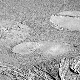 NASA's Mars Exploration Rover Opportunity shows a grainy image where the rover's airbags left impressions in the martian soil. The drag marks were made after the rover successfully landed at Meridiani Planum and its airbags were retracted.